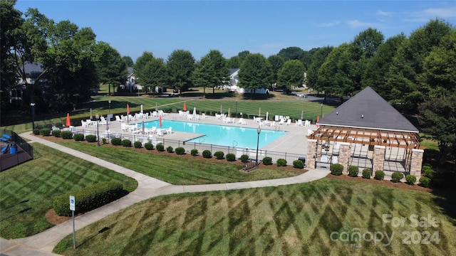 view of swimming pool with a yard