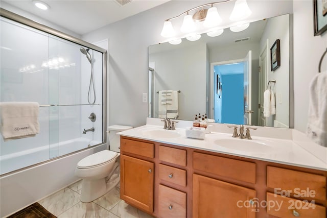 full bathroom with tile patterned flooring, toilet, combined bath / shower with glass door, and dual bowl vanity