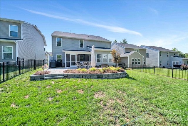 back of property with a patio area and a yard