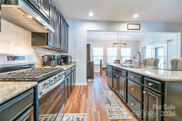 kitchen featuring appliances with stainless steel finishes, hardwood / wood-style floors, a wealth of natural light, and sink