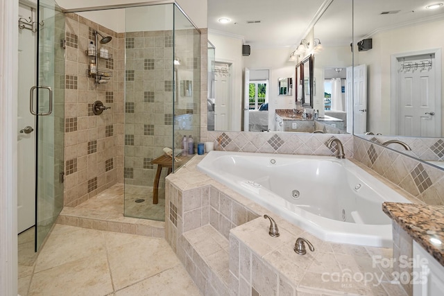 bathroom with plus walk in shower, crown molding, vanity, and tile patterned flooring