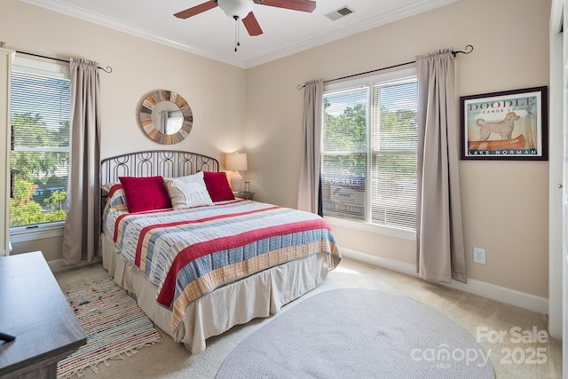 carpeted bedroom featuring ceiling fan and ornamental molding