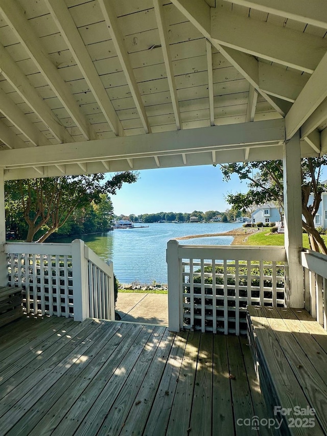 wooden deck featuring a water view