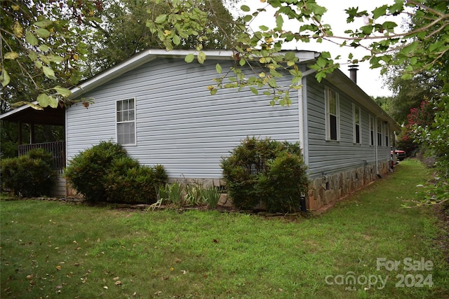 view of home's exterior with a yard