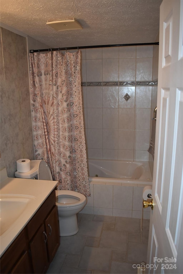 full bathroom with vanity, toilet, shower / tub combo, and a textured ceiling