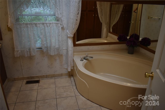 bathroom with tile patterned floors and a bathtub