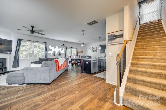 living room with ceiling fan and hardwood / wood-style floors