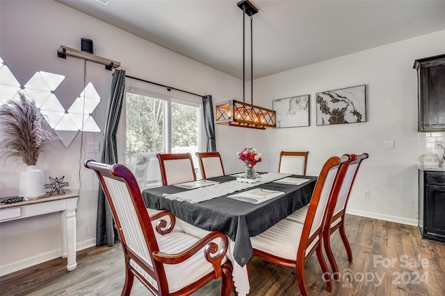 dining room with dark hardwood / wood-style flooring