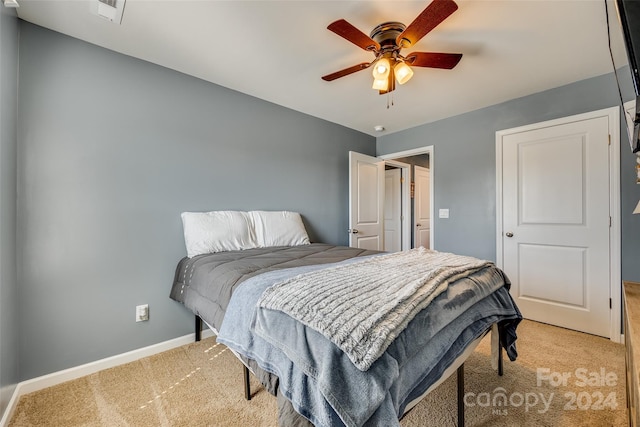 bedroom featuring ceiling fan and light carpet