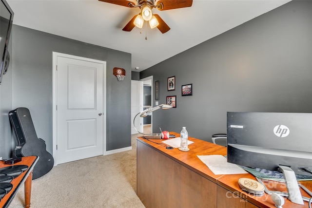 carpeted home office featuring ceiling fan