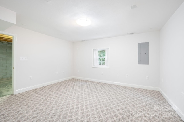 empty room with electric panel and carpet