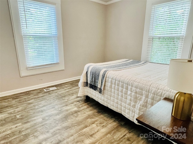 bedroom with hardwood / wood-style flooring