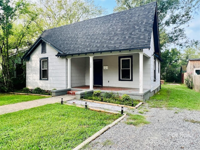 view of front of house featuring a front lawn and covered porch