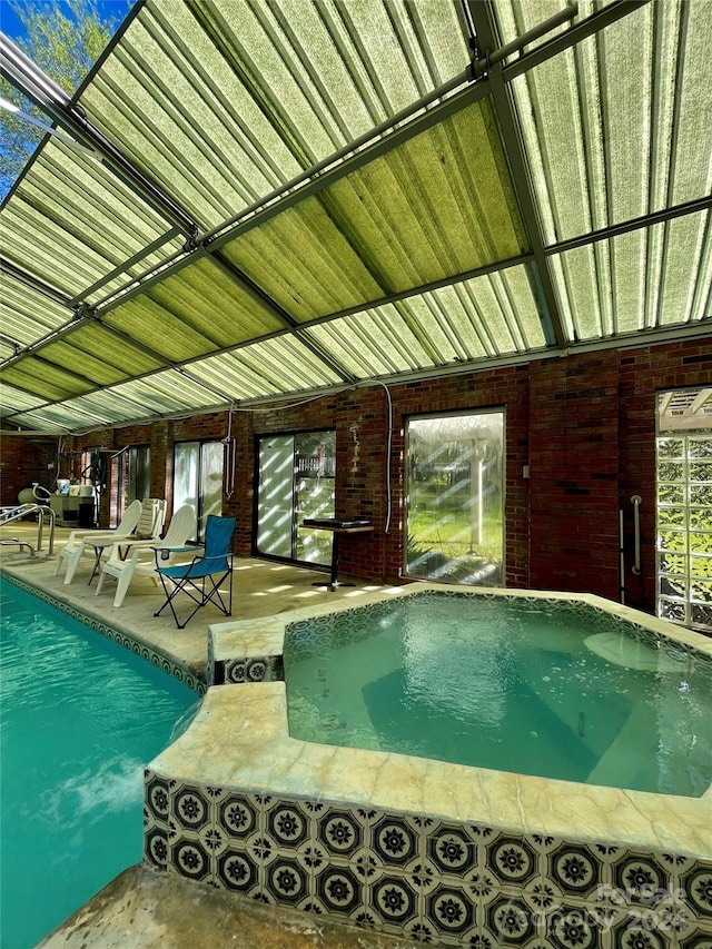 indoor pool featuring a patio area