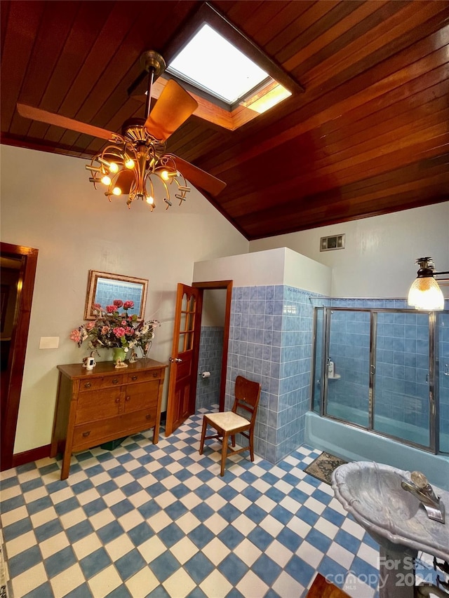 full bathroom with a skylight, wood ceiling, visible vents, and bath / shower combo with glass door