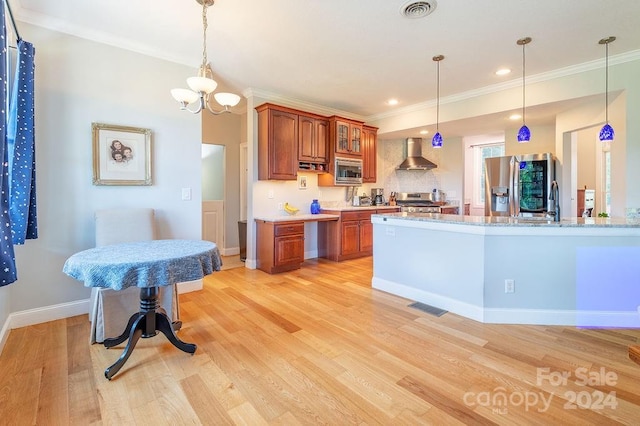 kitchen featuring wall chimney range hood, light hardwood / wood-style flooring, stainless steel appliances, ornamental molding, and light stone countertops