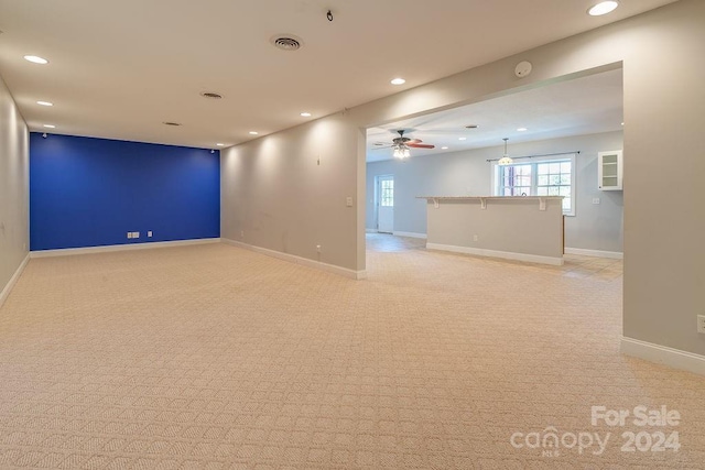 carpeted spare room with ceiling fan