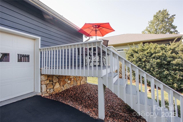 view of side of property with covered porch and a garage