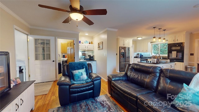 living room with ceiling fan, crown molding, and light hardwood / wood-style floors