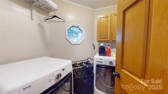 clothes washing area featuring washing machine and clothes dryer and cabinets