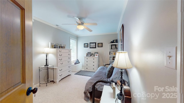 bedroom with ceiling fan, light colored carpet, and crown molding