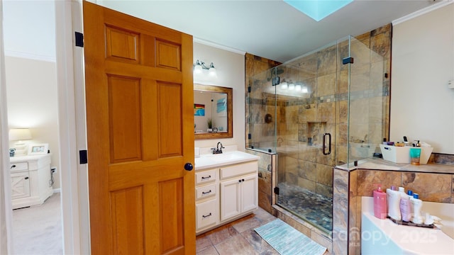 bathroom with crown molding, an enclosed shower, vanity, and a skylight