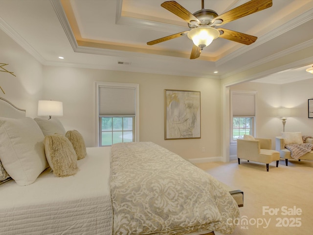 bedroom with a tray ceiling, ceiling fan, and crown molding