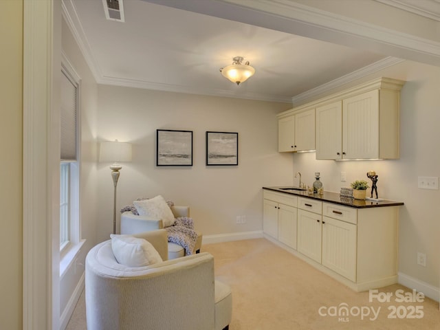 sitting room with crown molding, light colored carpet, and sink