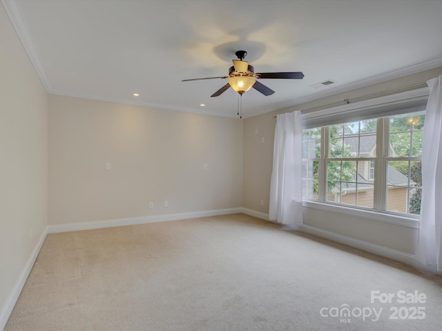 carpeted empty room featuring ceiling fan and ornamental molding