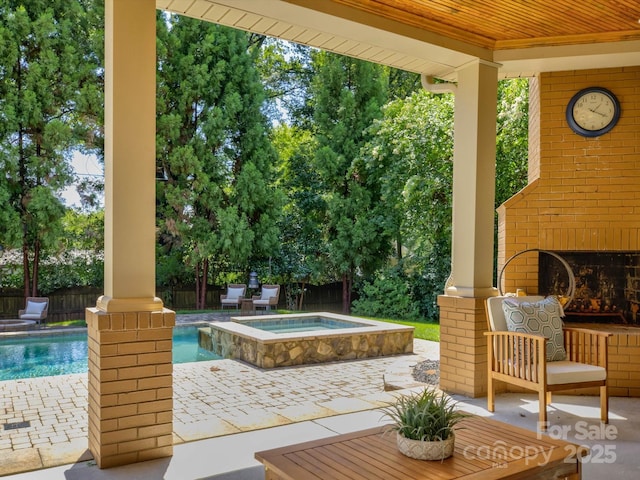 exterior space featuring an outdoor brick fireplace and a pool with hot tub