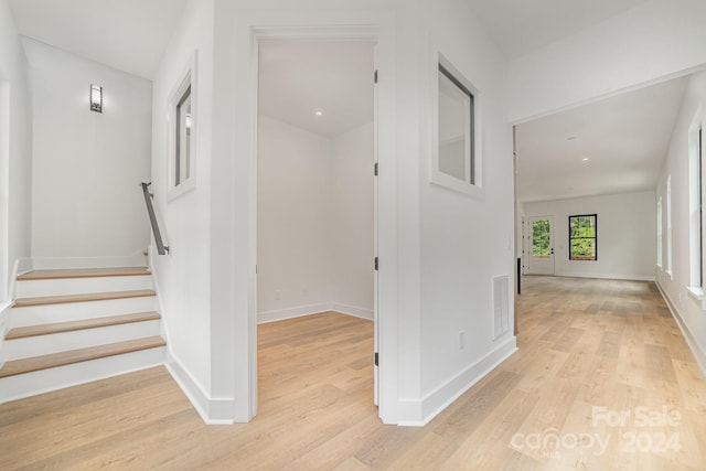 hallway with light hardwood / wood-style floors