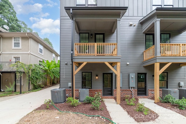 view of property with a balcony and central AC unit