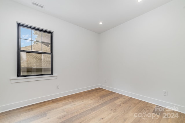 empty room with light hardwood / wood-style flooring