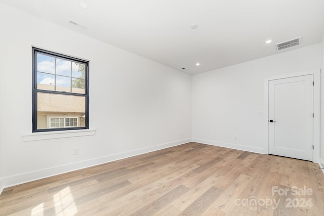 spare room featuring light hardwood / wood-style flooring