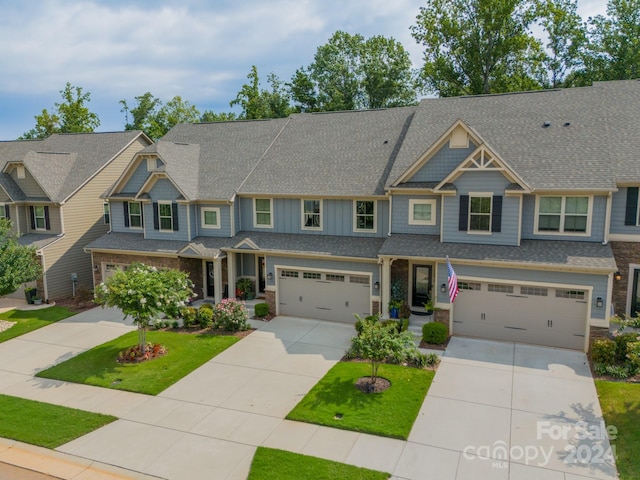 view of front of property with a front yard and a garage