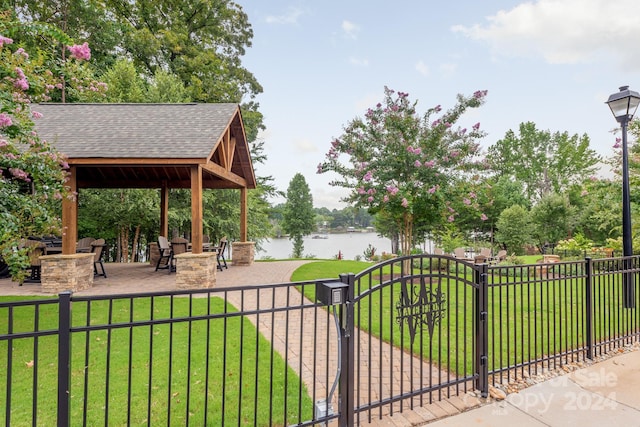 view of home's community featuring a water view, a yard, a patio area, and a gazebo