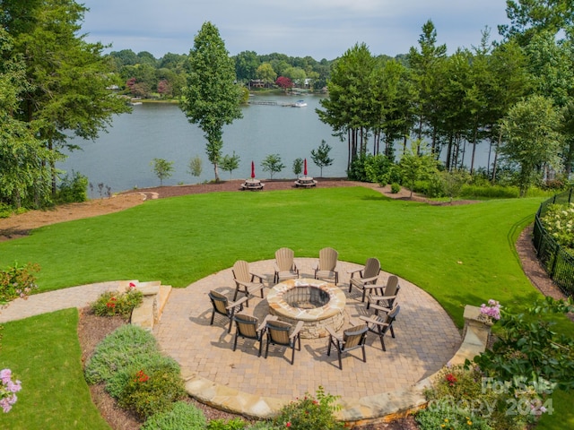 view of yard with a patio, a water view, and an outdoor fire pit