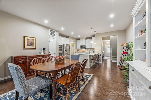 dining room with sink and dark hardwood / wood-style flooring