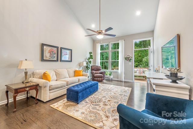 living room featuring ceiling fan, high vaulted ceiling, and dark wood-type flooring