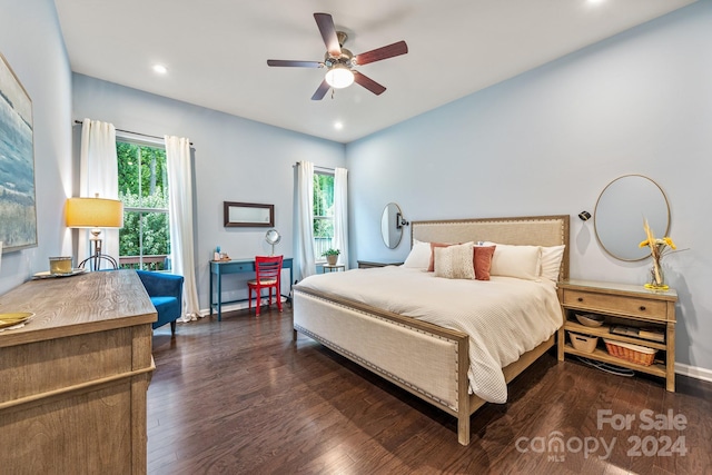 bedroom featuring dark wood-type flooring, ceiling fan, and multiple windows