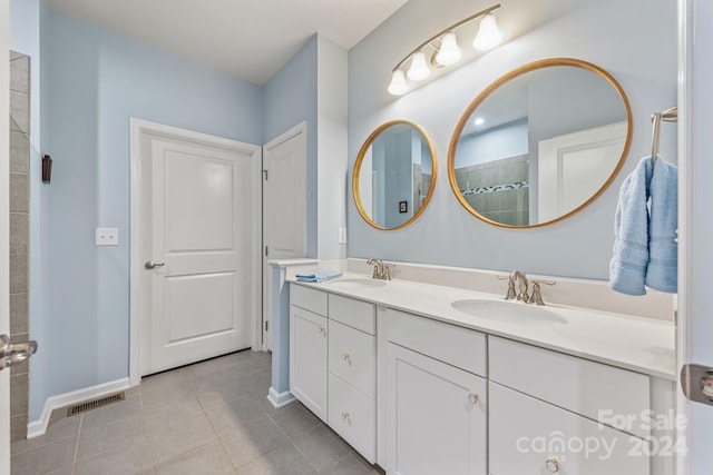 bathroom featuring tile patterned floors and double vanity