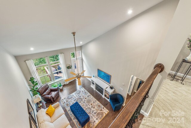 carpeted living room featuring high vaulted ceiling