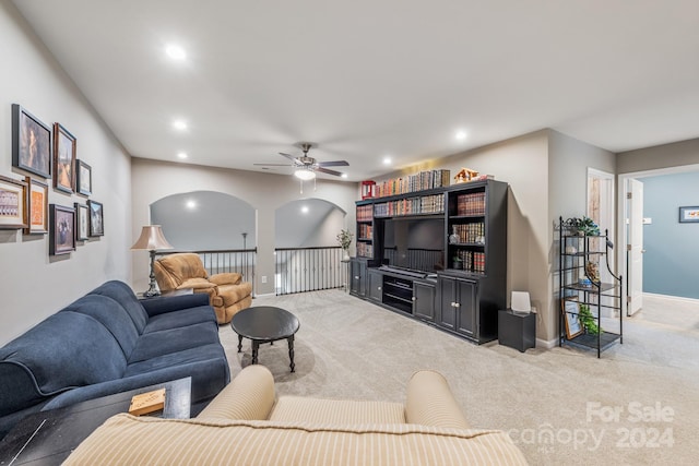 carpeted living room with ceiling fan