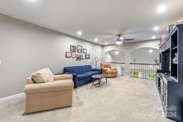 living room featuring light carpet and ceiling fan