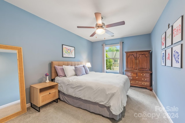 bedroom with ceiling fan and light colored carpet