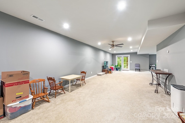 recreation room featuring ceiling fan, french doors, and light carpet