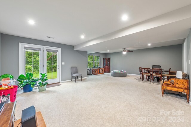 sitting room with ceiling fan and carpet flooring