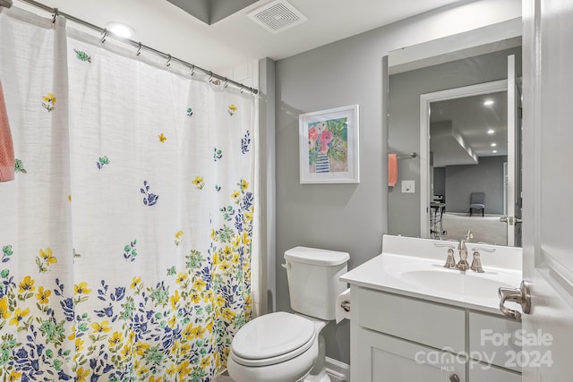 bathroom featuring vanity, toilet, and a shower with shower curtain