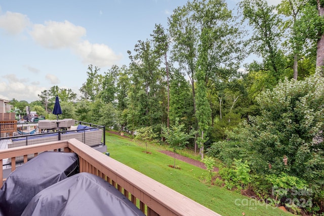 wooden deck with a lawn