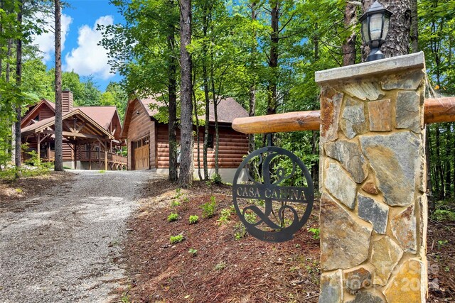 view of front of property with a garage and a carport